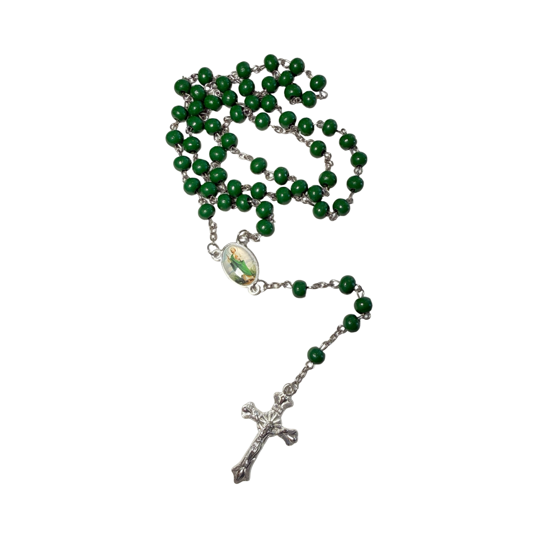 Green rosary with a cross on a white background