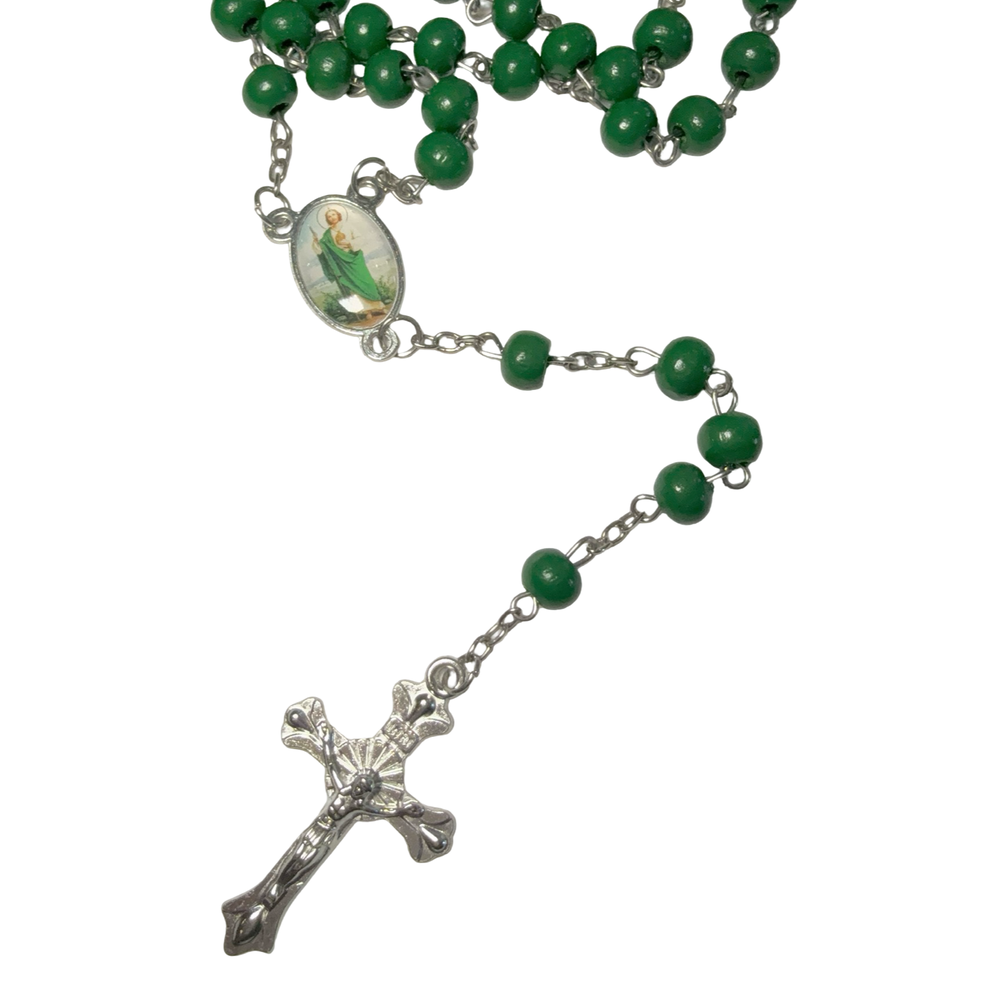 Green rosary with a silver cross on a white background