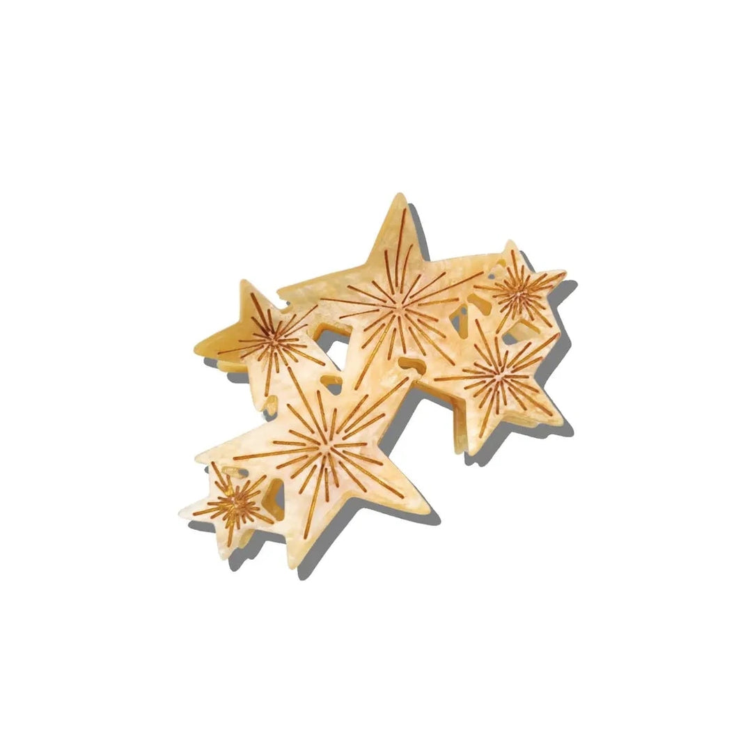 Clustered star-shaped claw hair clip with a warm marbled finish and etched sunburst details.