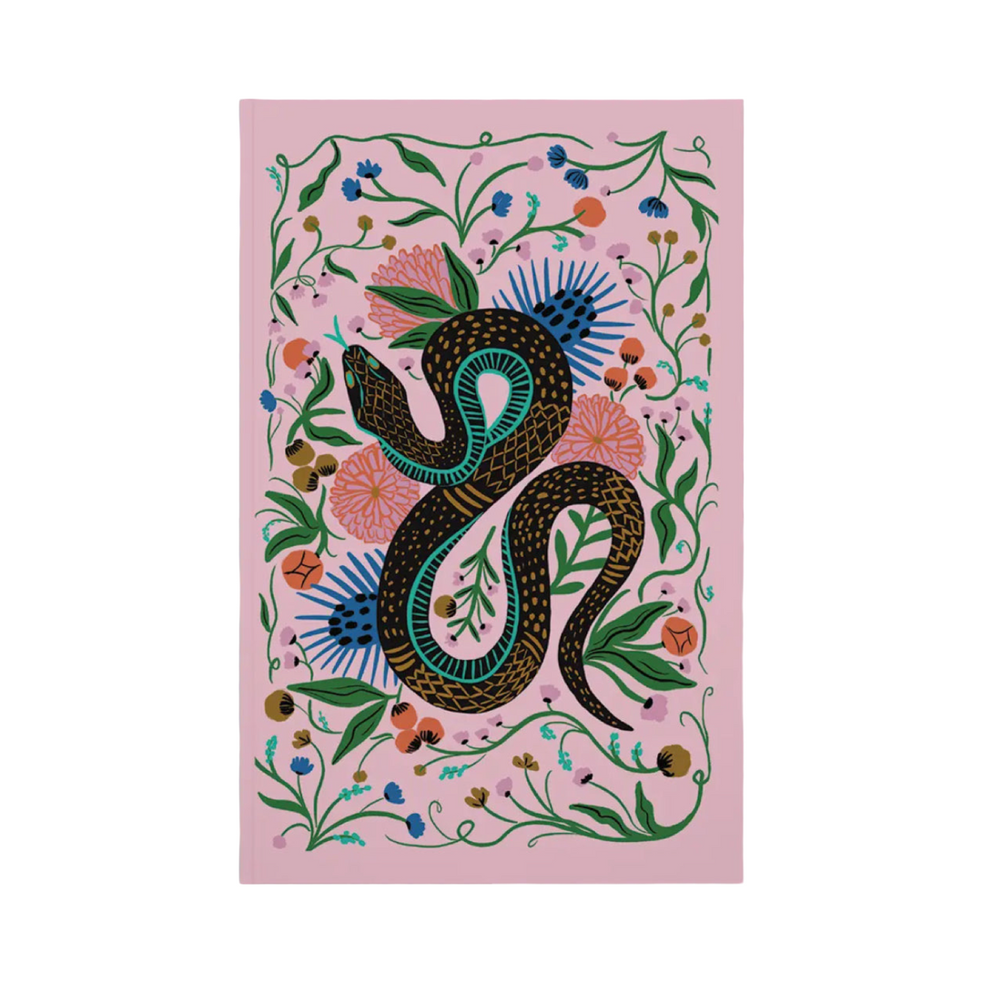 Pink journal featuring a stylized black-and-teal snake coiled among colorful flowers and green vines in a folk-art style.
