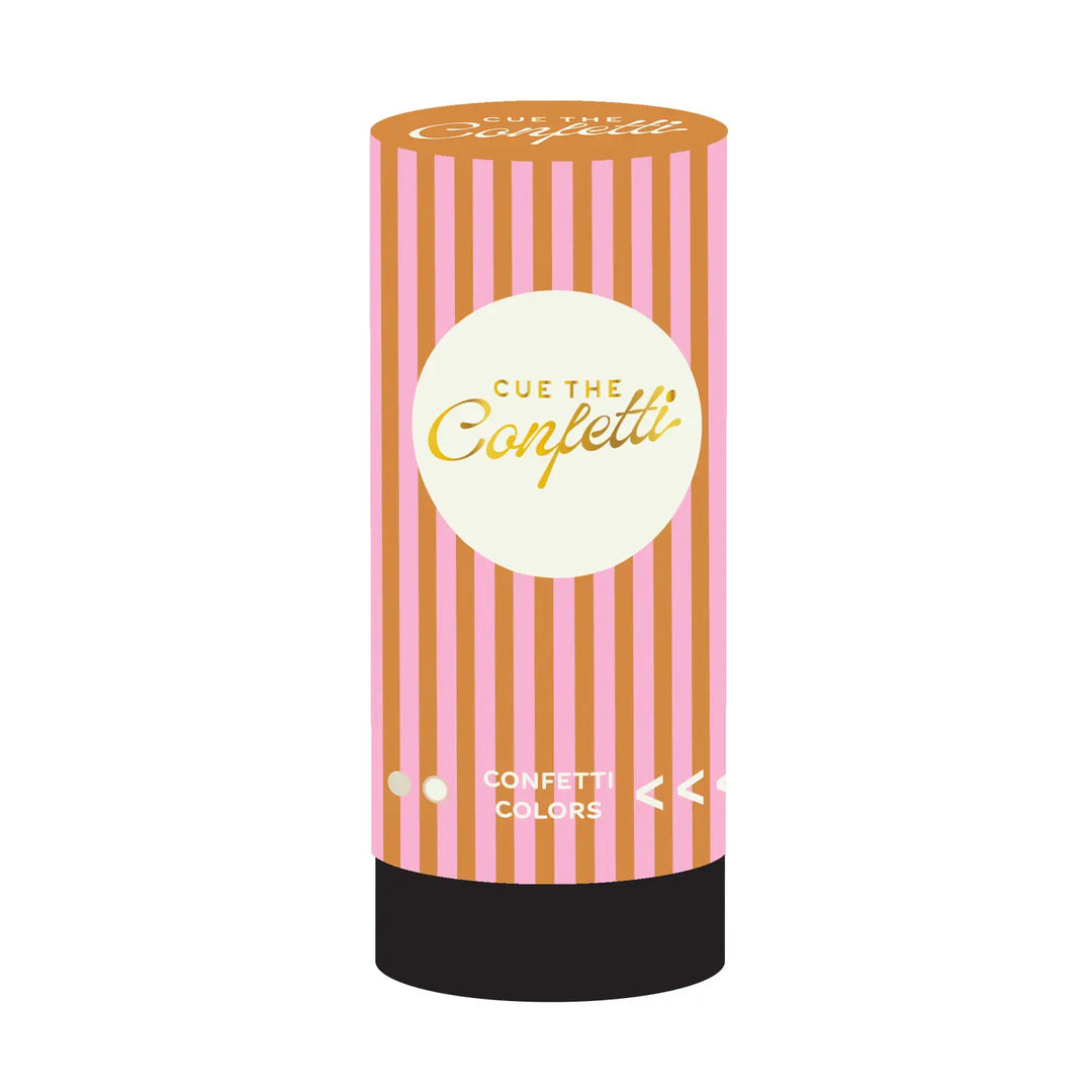 Pink and orange striped cylindrical confetti popper labeled “Cue the Confetti” with a round cream-colored label and black base.