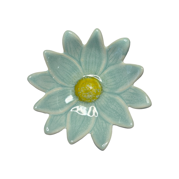 Stoneware daisy-shaped dish in aqua with a yellow center glaze