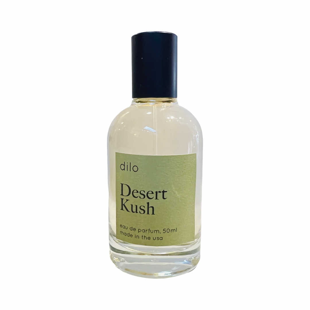 Clear glass bottle with black cap and green dilo Desert Kush branded label.