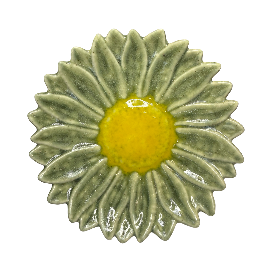 Stoneware flower-shaped dish in sage green with a yellow center glaze
