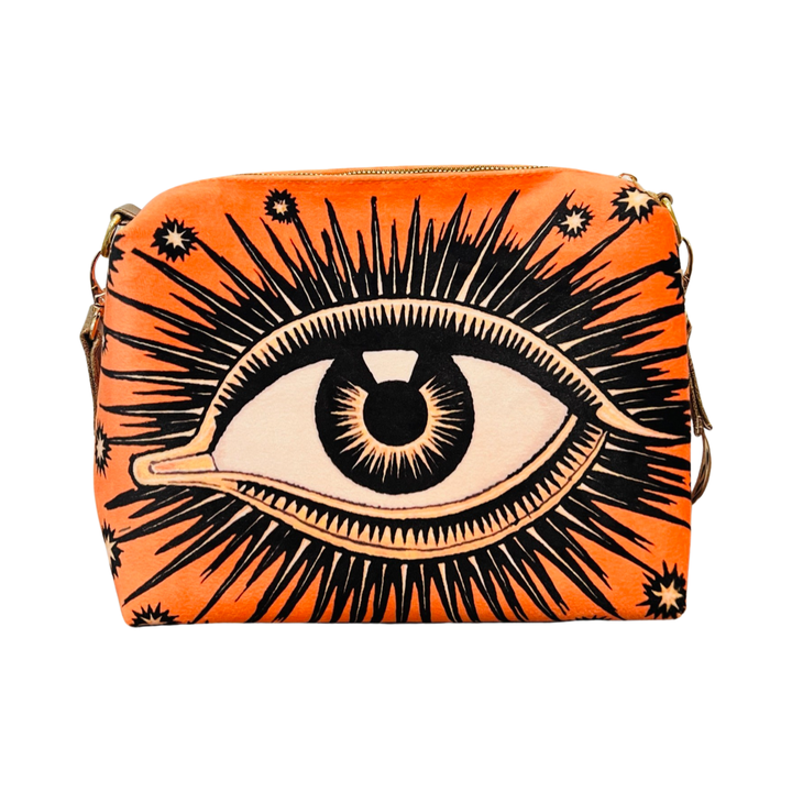 orange bag with an image of an eye featuring eyelashes and stars