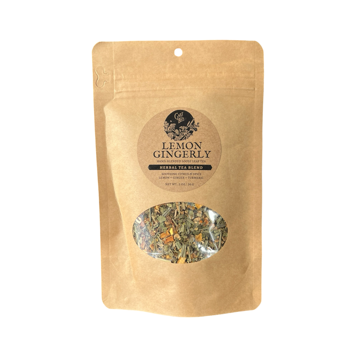 2 oz kraft pouch of Lemon Gingerly tea with a branded label and a clear window that displays the dried herbs and flowers that makes the tea.