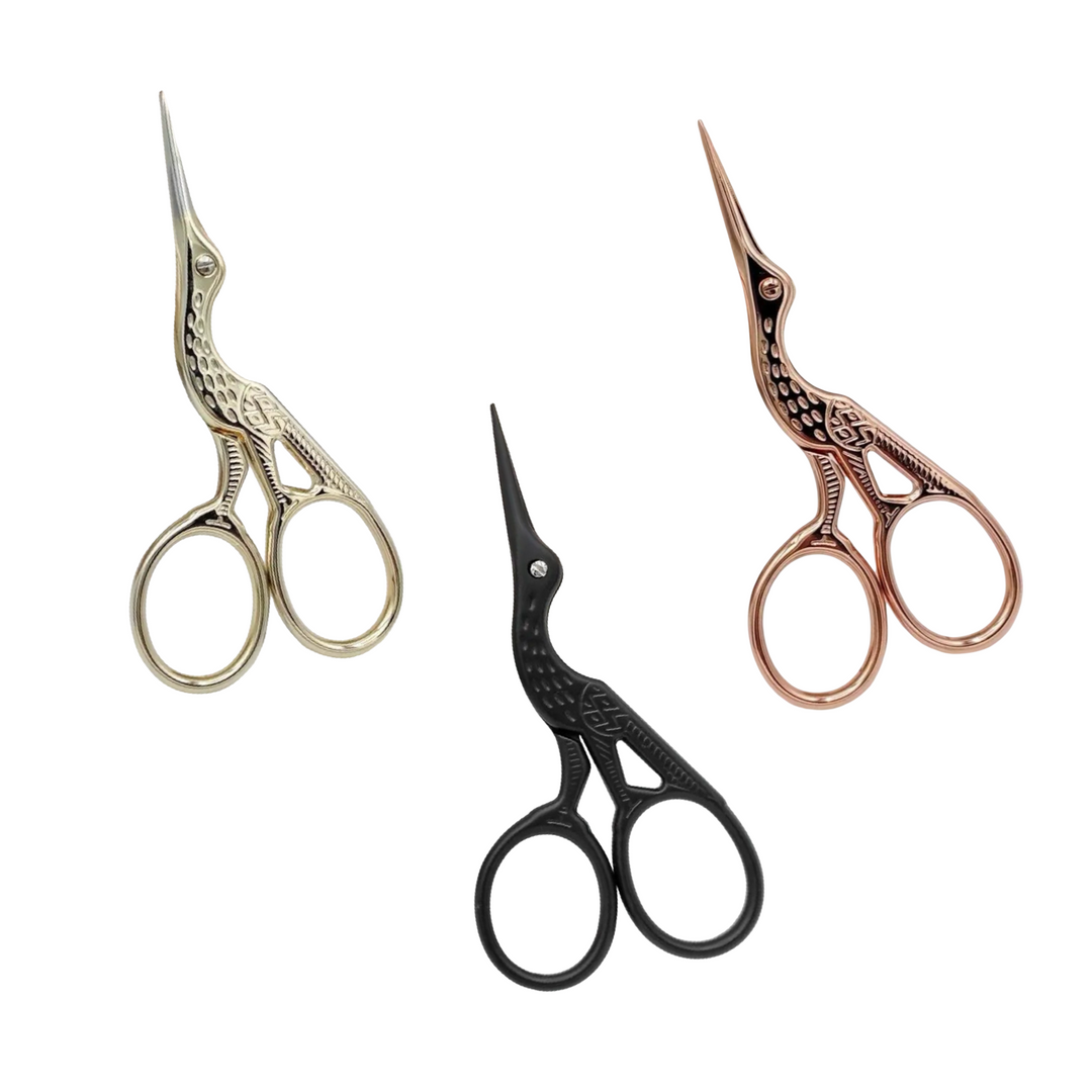 set of 3 stork shaped scissors in three colors: light gold, black and rose gold.