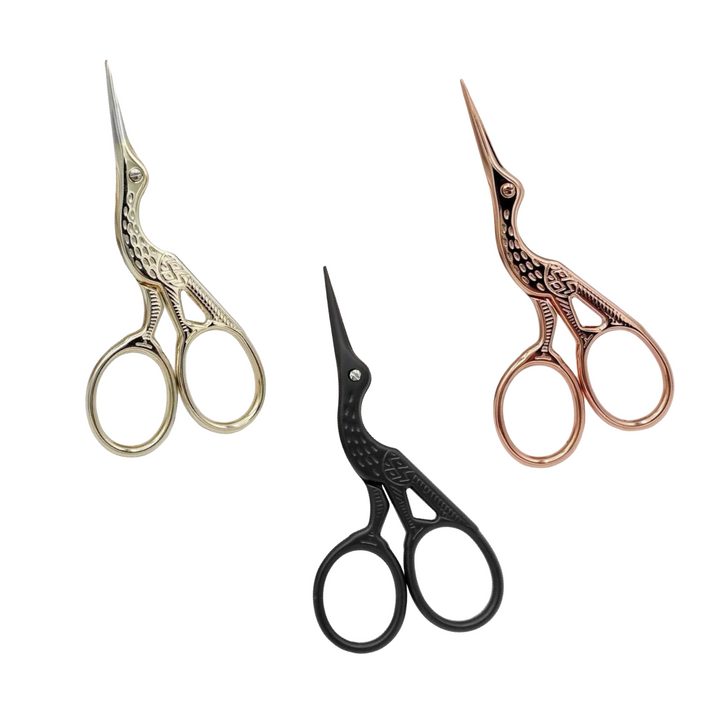 set of 3 stork shaped scissors in three colors: light gold, black and rose gold.