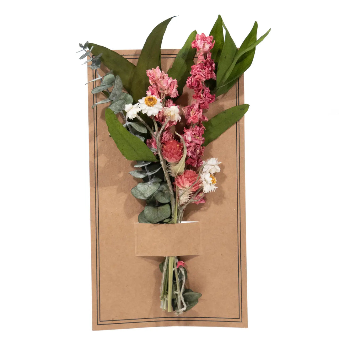 Floral arrangement in a cardboard holder on a white background