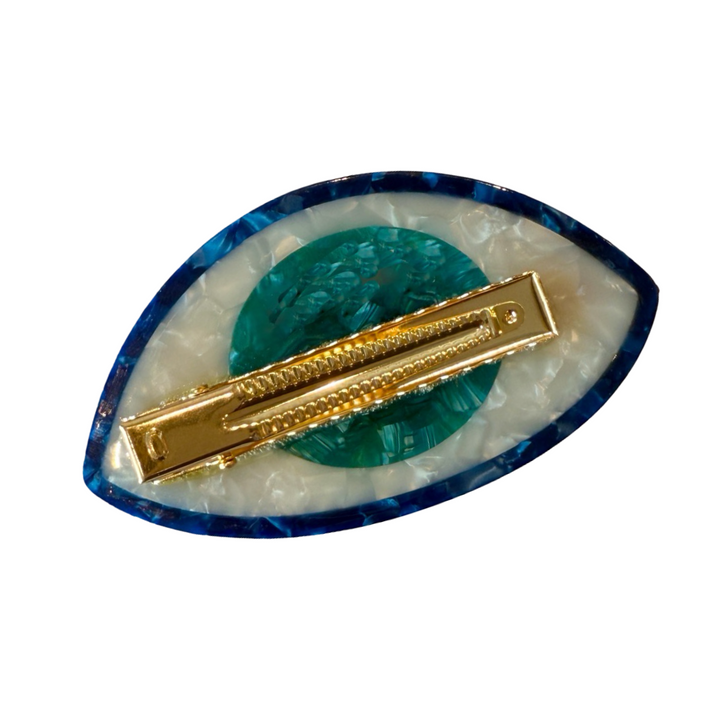 back of a Shiny Evil Eye hair barrette with blue, turquoise, white, and black detailing, shaped like an eye featuring a gold alligator clip.