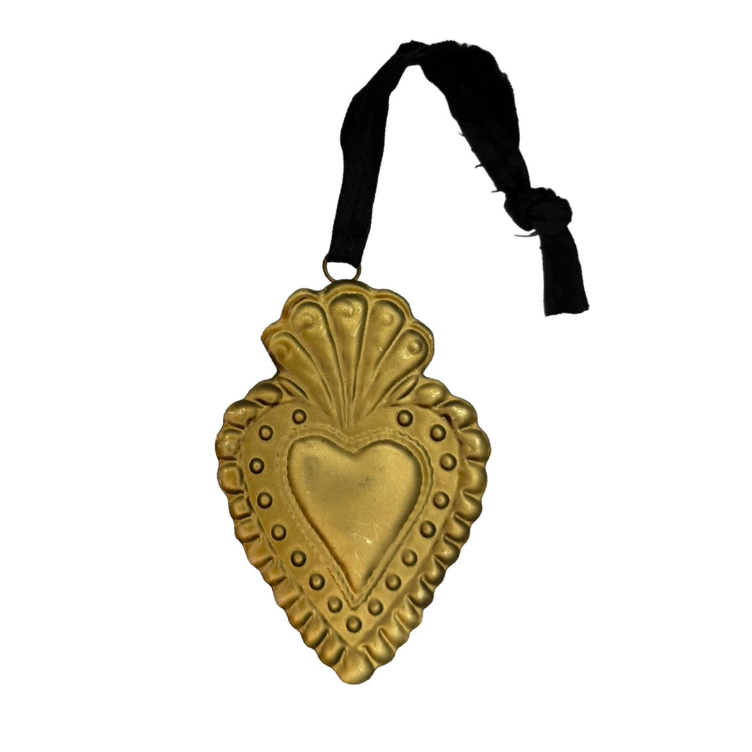 Gold embossed sacred heart ornament features dark ribbon hanger.