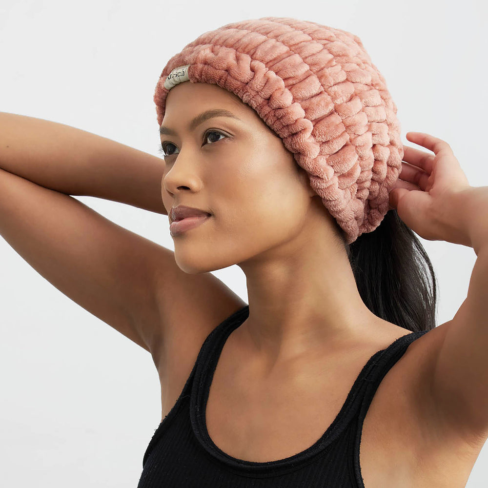a woman in a black tank top wearing a dusty rose wide headband. Brand: Kitsch