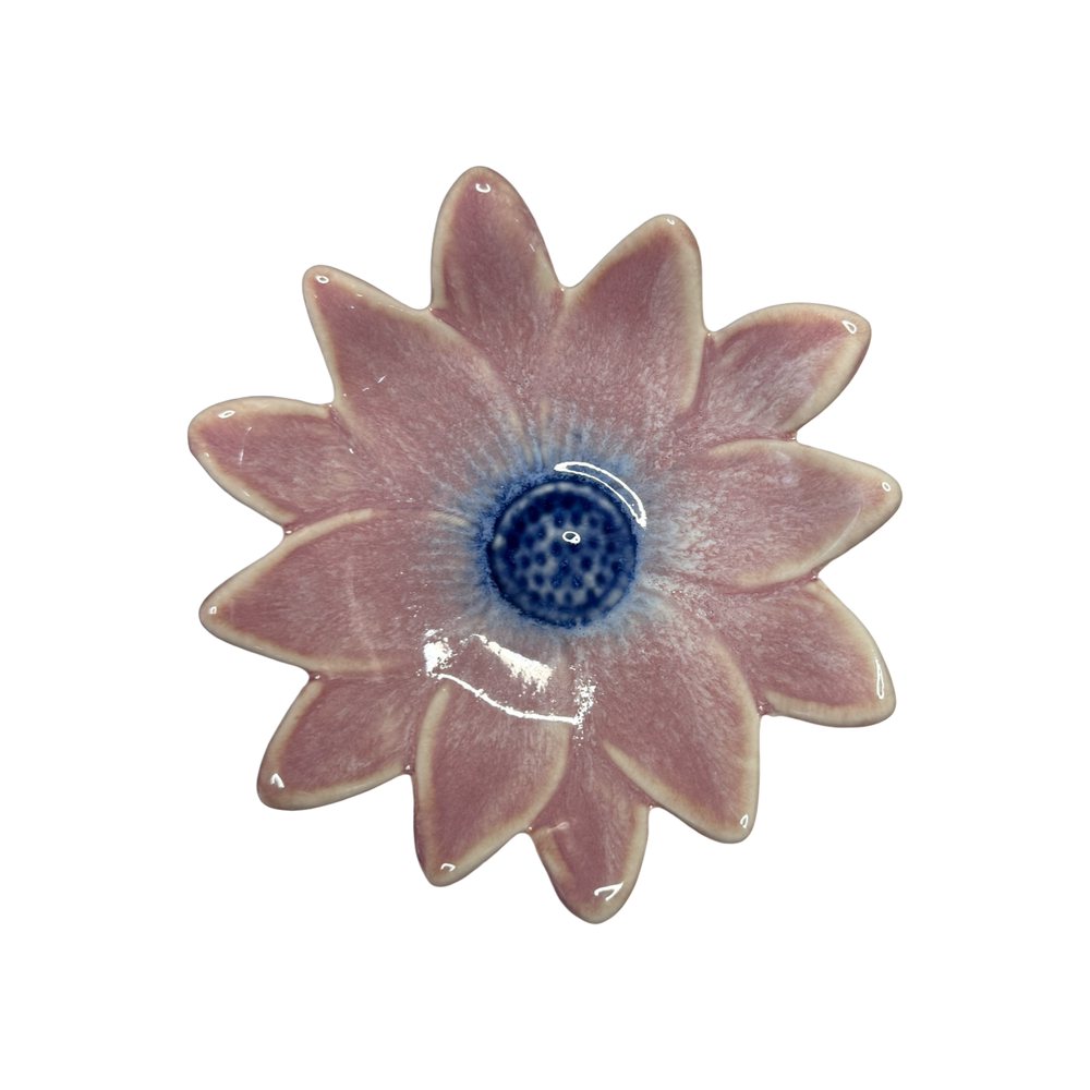 Stoneware daisy-shaped dish in dusty rose with a blue center glaze