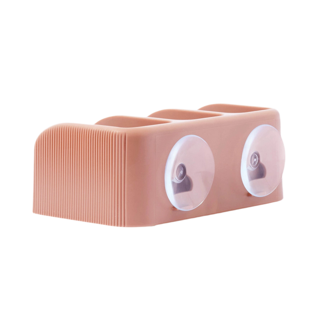 back view of a light pink soap dish with two suction cups