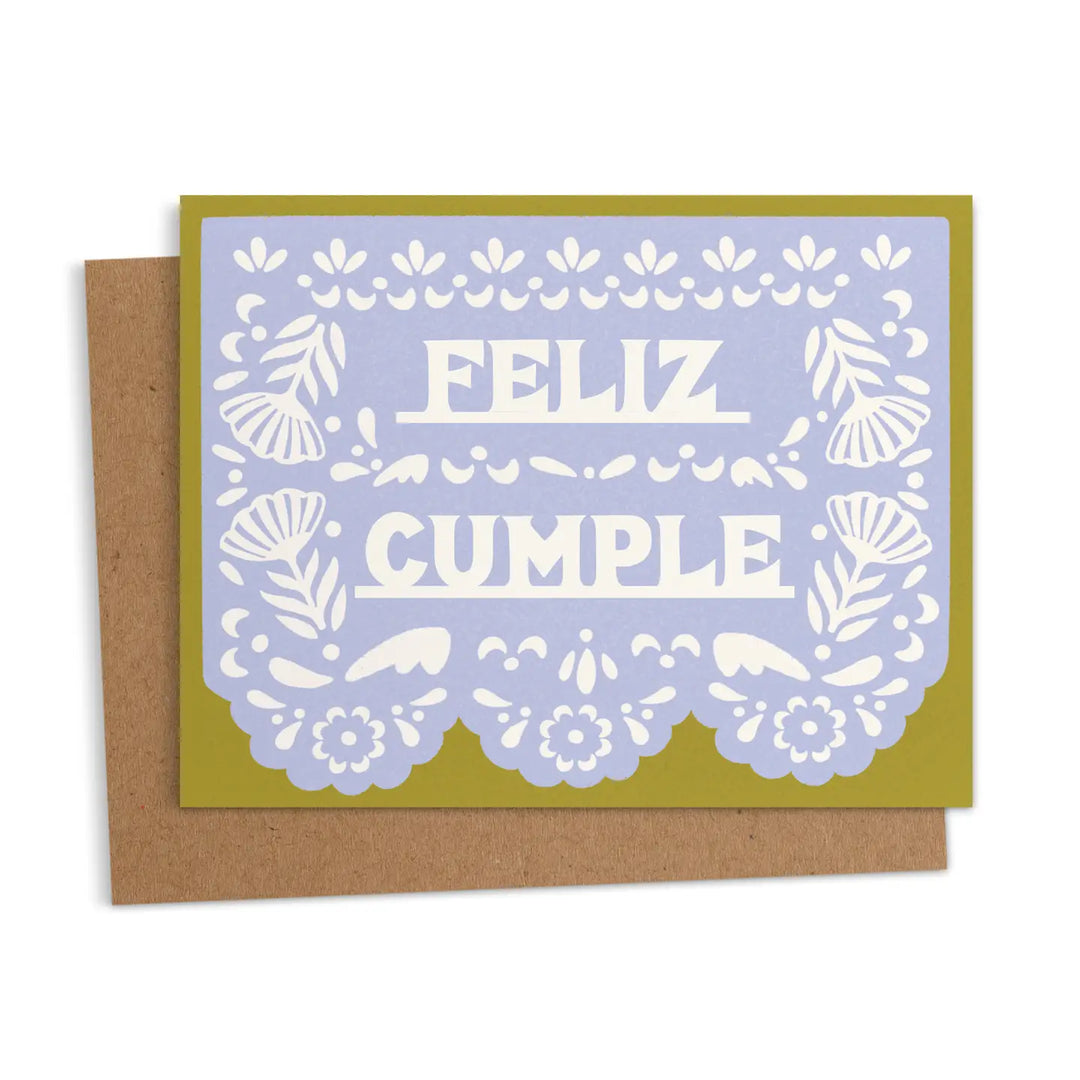 Birthday card with a lavender papel picado style design that reads “Feliz Cumple,” shown with a kraft envelope.