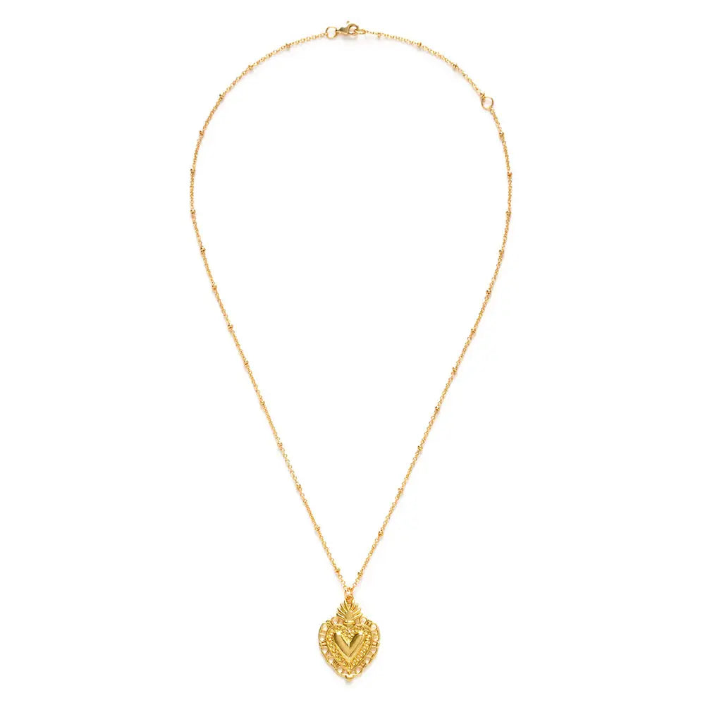gold sacred heard pendant on a gold chain.