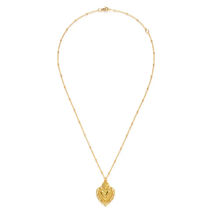 gold sacred heard pendant on a gold chain.