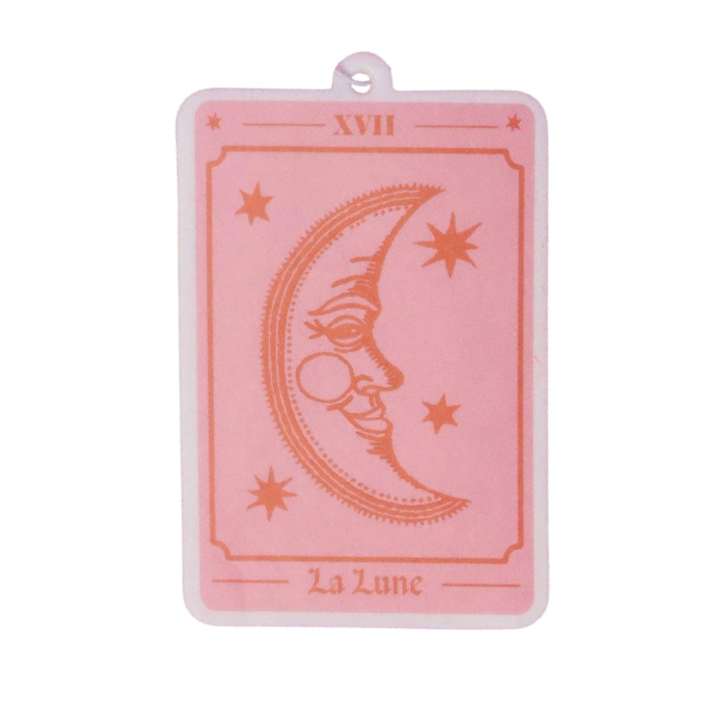 Pink rectangle freshener with a white border and an illustration of a moon, stars and roman numerals. 