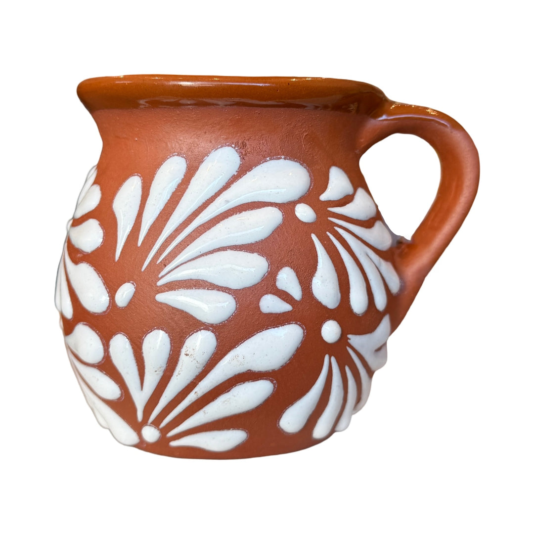 Terracotta mug with a white glazed talavera design. 