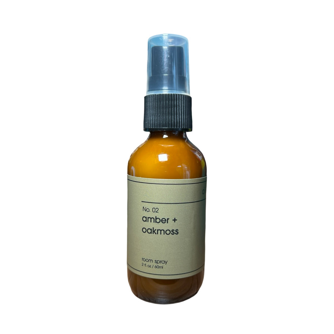 2 fl oz brown spray bottle of amber and oakmoss room spray