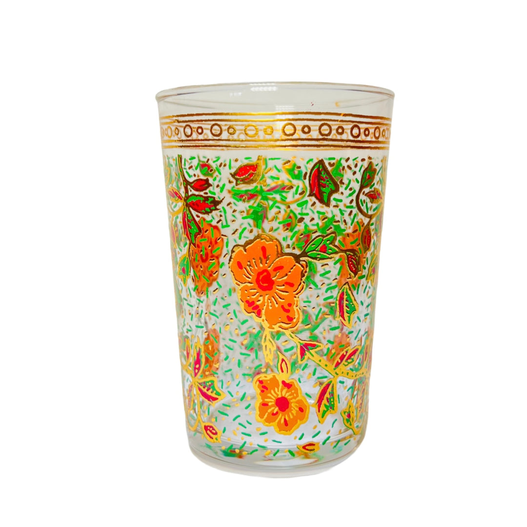 Clear glass featuring intricate floral designs in vibrant hues of orange, green, and pink with gold accents.