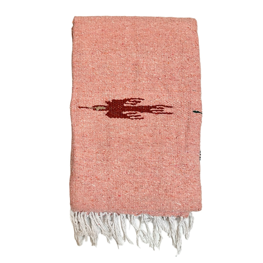 quarter folded dusty pink woven blanket with a red bird design