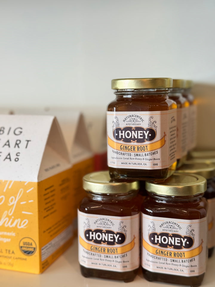 Jars of Honey Ginger Root honey with a box in the background