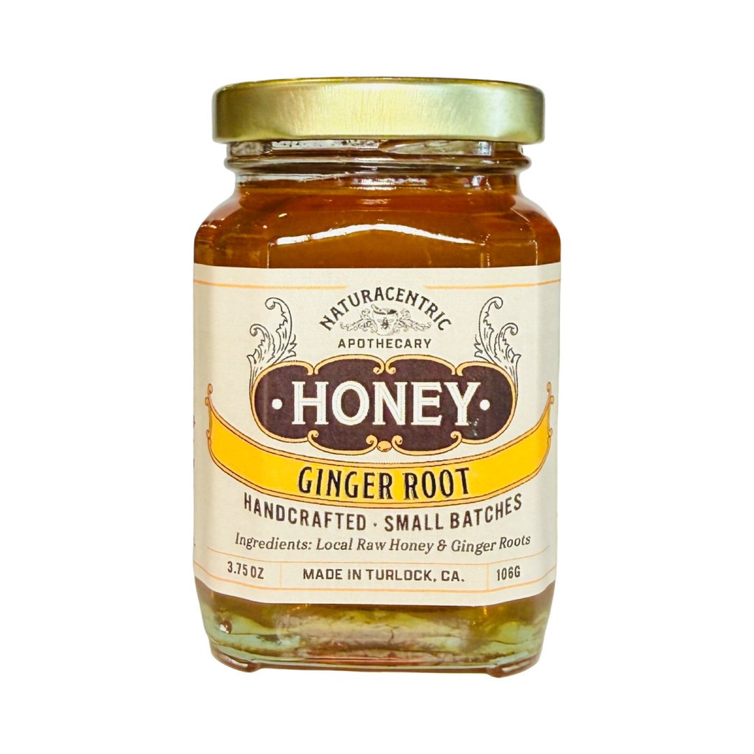 A 3.75 glass jar of Naturacentric Apothecary Ginger Root infused honey with a gold lid and vintage-style label
