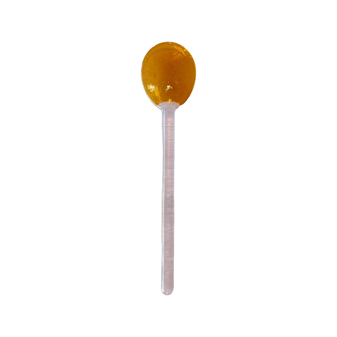 Light pink glass spoon with an amber bowl.