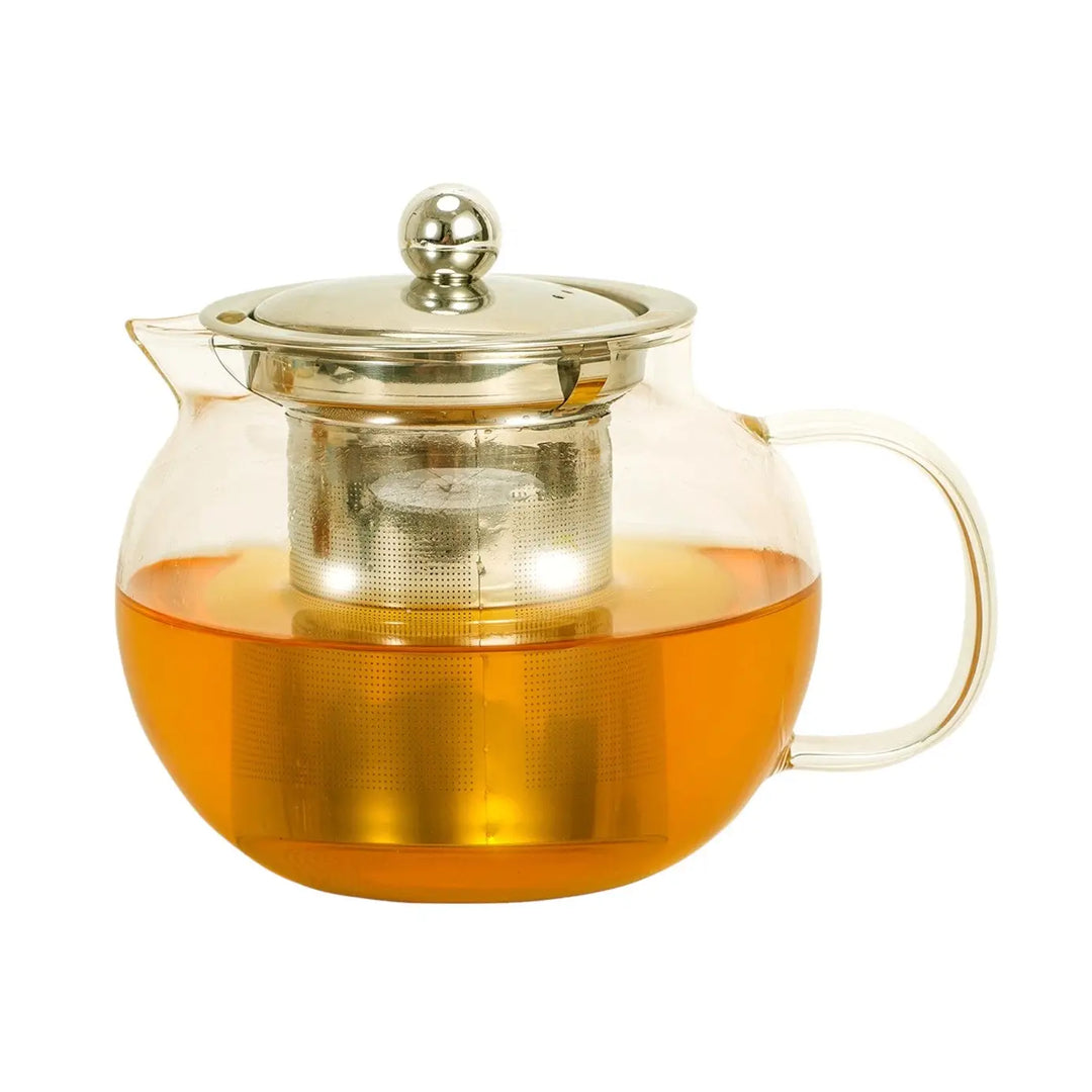 Clear glass teapot half filled with amber colored tea has a metal infuser and silver lid with ball styled knob.