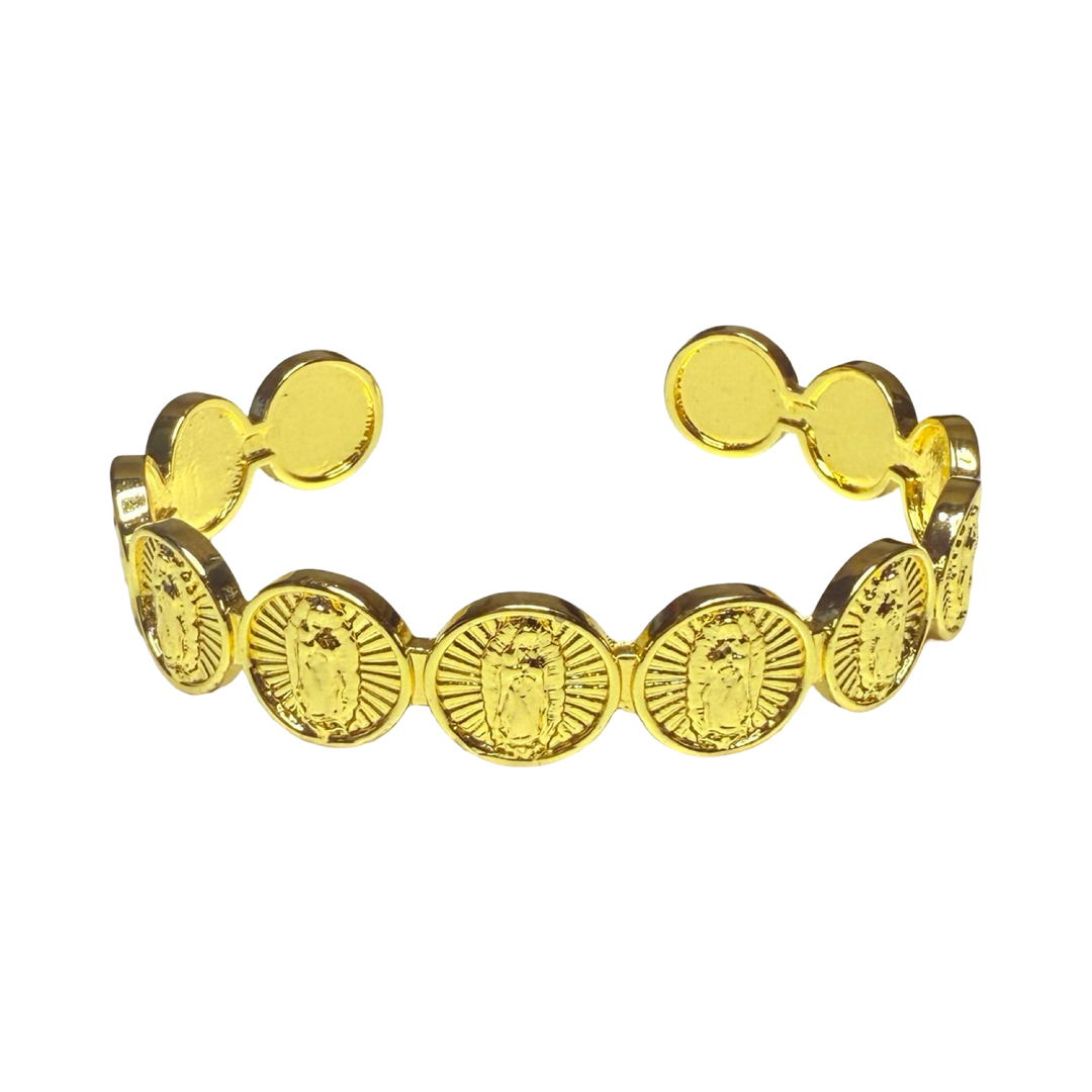 A gold-tone cuff bracelet with repeating round Our Lady of Guadalupe medallions.