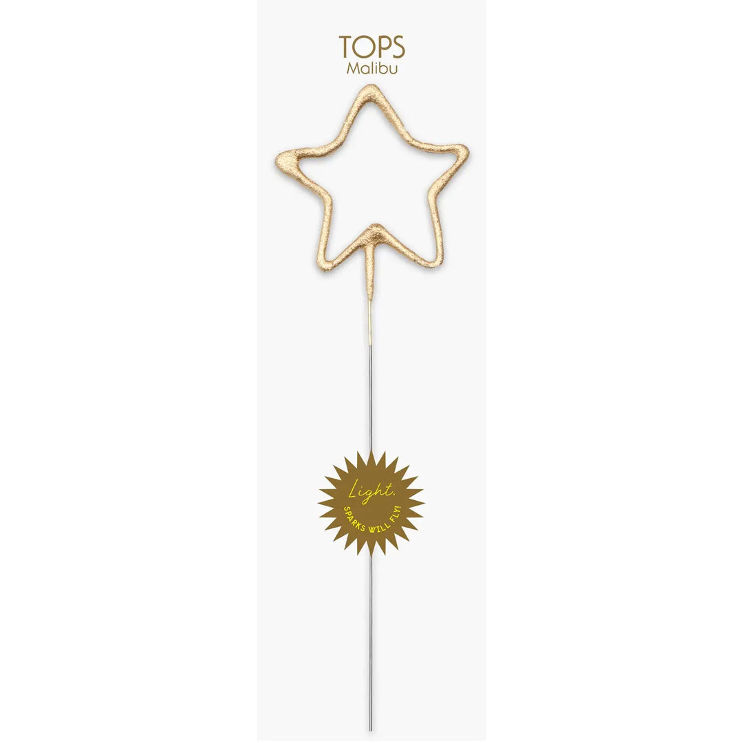 Gold star-shaped sparkler wand on a white card.