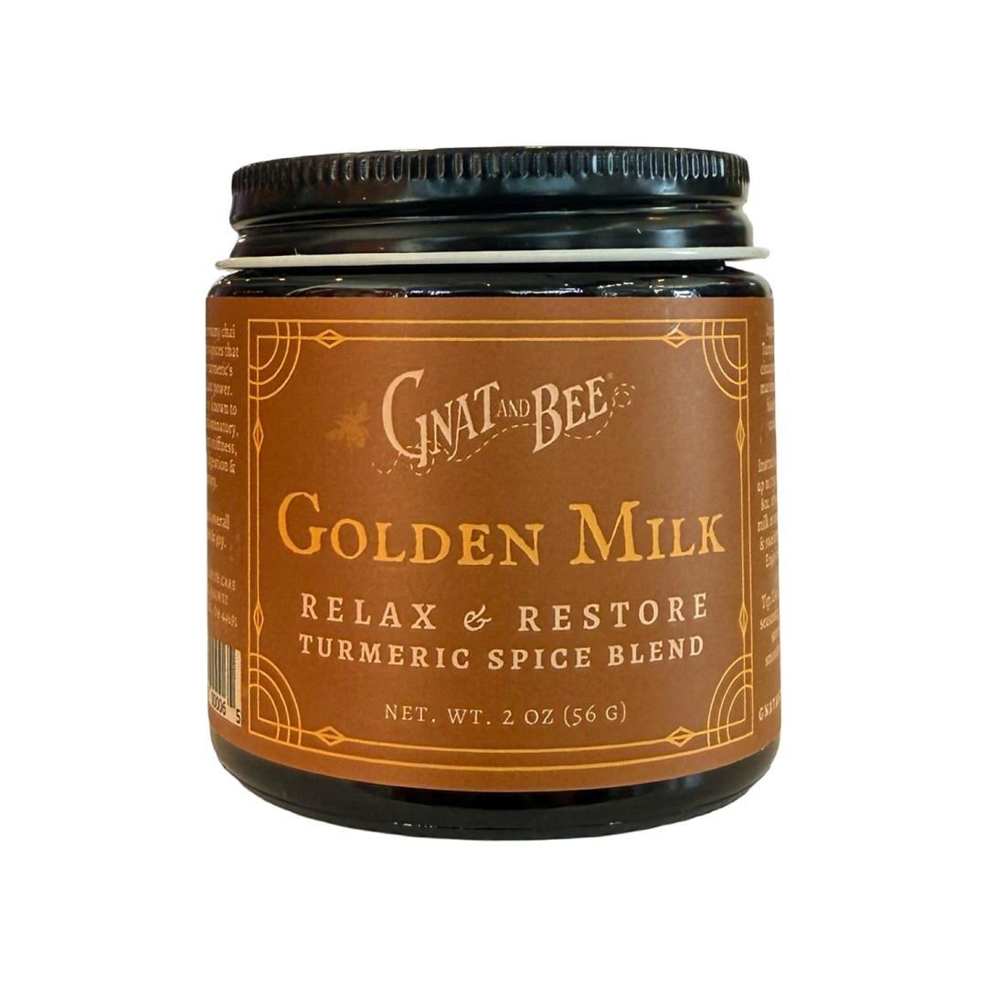 A 2.0 oz dark glass jar of Gnat and Bee Golden Milk Relax and Restore Turmeric Spice Blend with a warm brown and gold label.