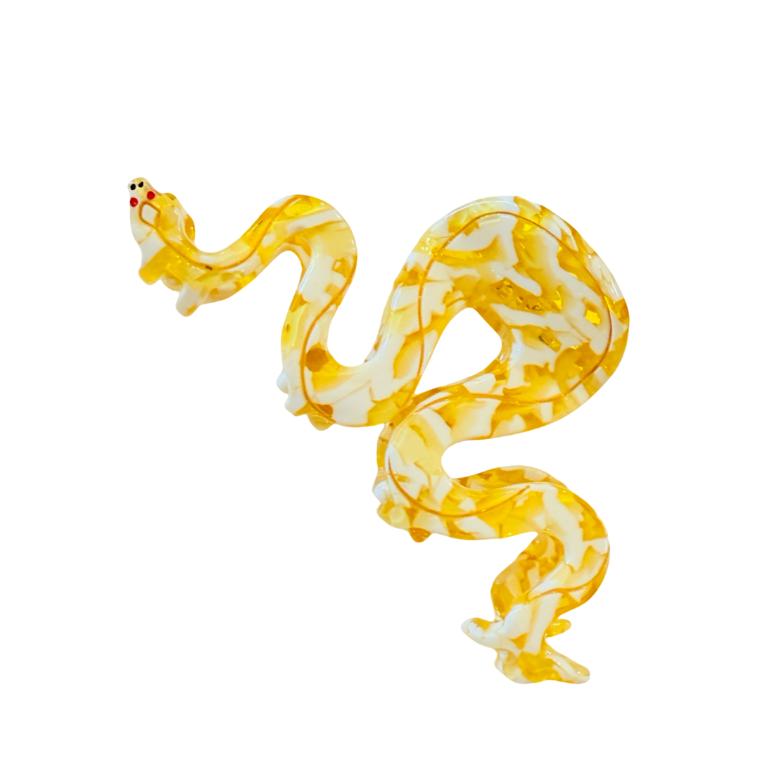Photo of hair clip shaped like a golden python with red eyes.
