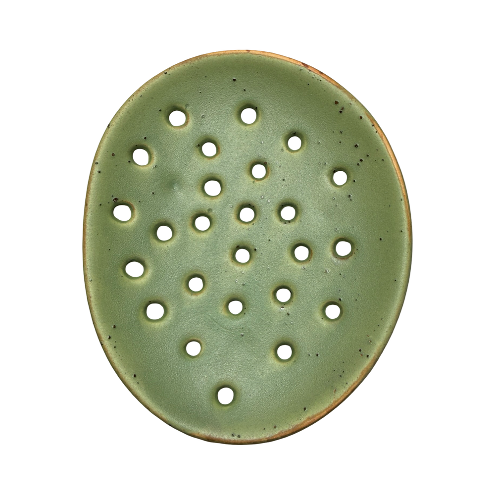 round ceramic footed soap dish with perforated drainage holes, shown in green.