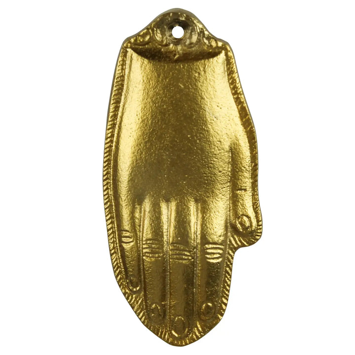 A gold-colored metal Milagro hand charm with intricate detailing on the palm and fingers.