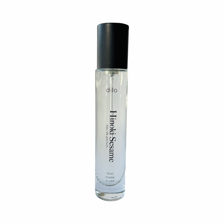 15mL cylindrical glass Hinoki Sesame eau de parfum spray bottle with black text branding and content description.