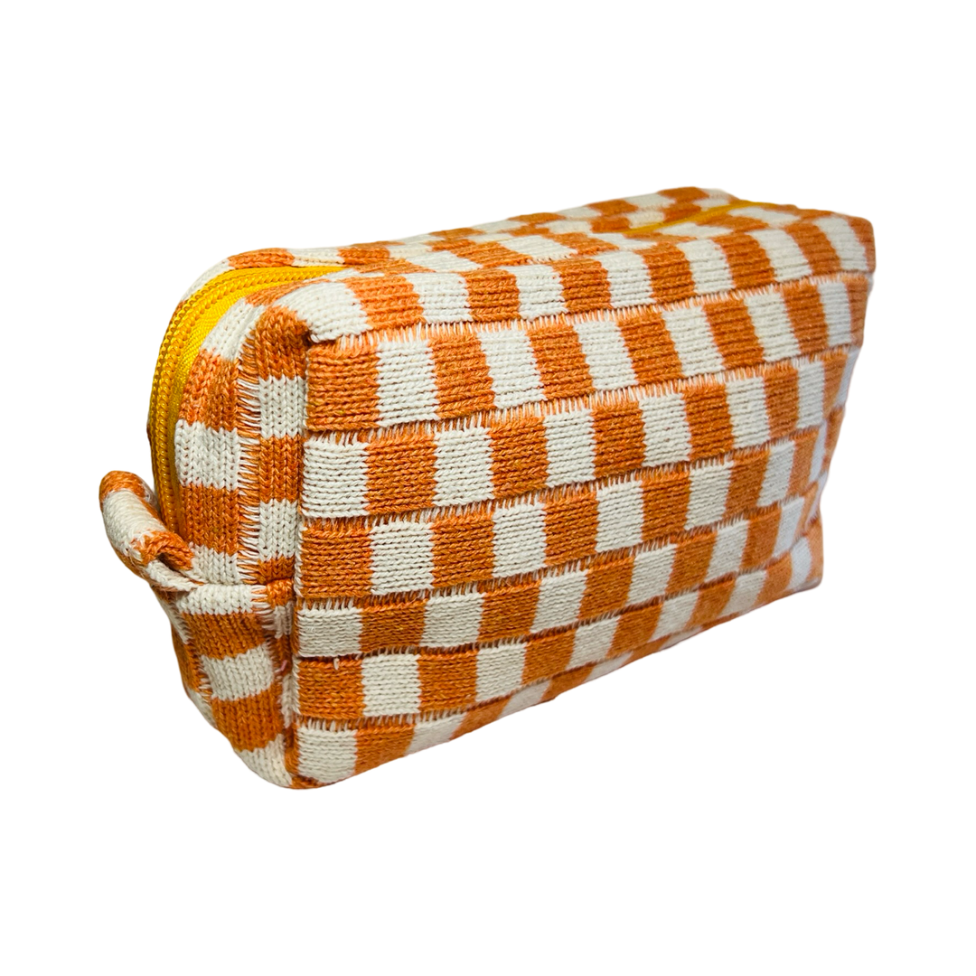 side view of a rectangle cosmetic bag with a orange and white checkered design