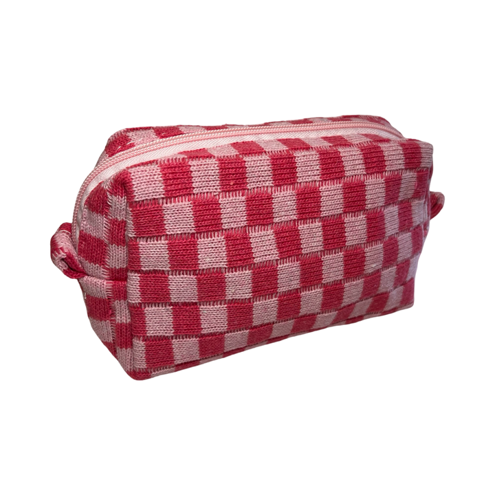 side view of a rectangle cosmetic bag with a light and dark pink checkered design