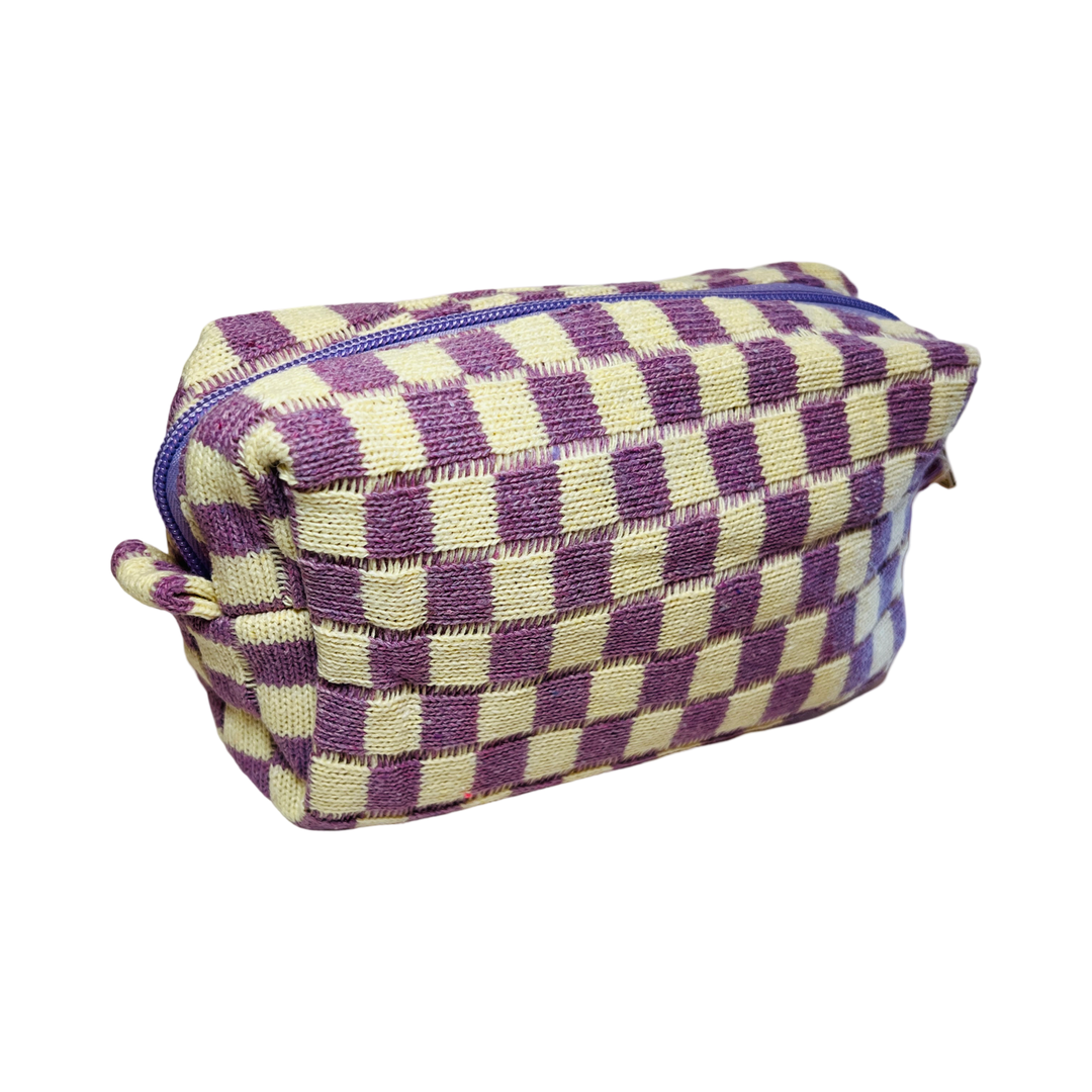 side view of a rectangle cosmetic bag with a purple and white checkered design