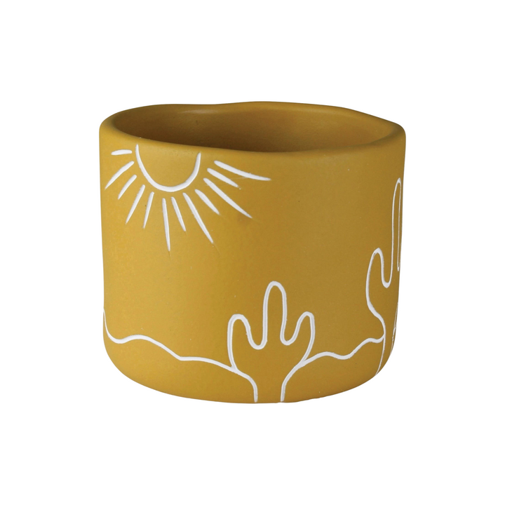 golden yellow cement cachepot with a desert landscape design in white.