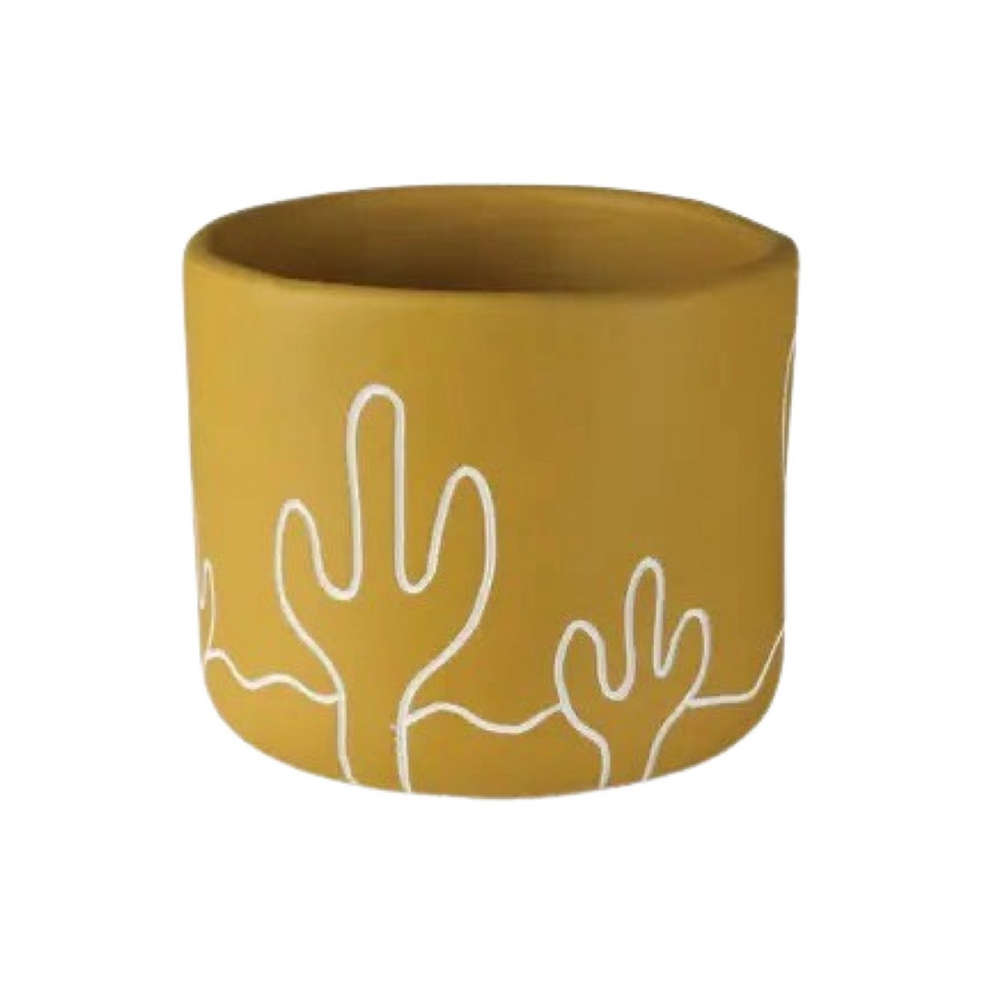 golden yellow cement cachepot with a desert landscape design in white.