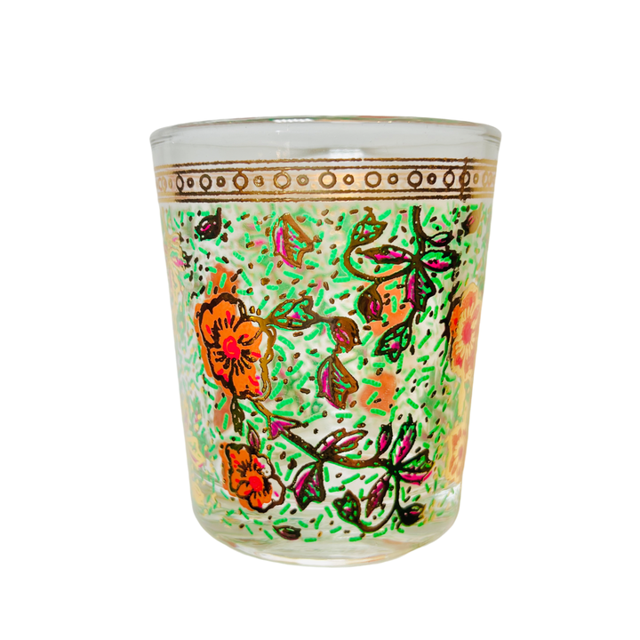 Clear glass featuring intricate floral designs in vibrant hues of orange, green, and pink with gold accents.