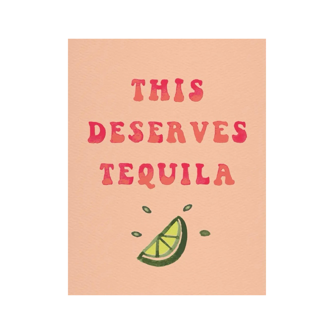 Greeting card with the phrase "This Deserves Tequila" in red lettering on a peach background, featuring a hand-drawn lime wedge below the text.