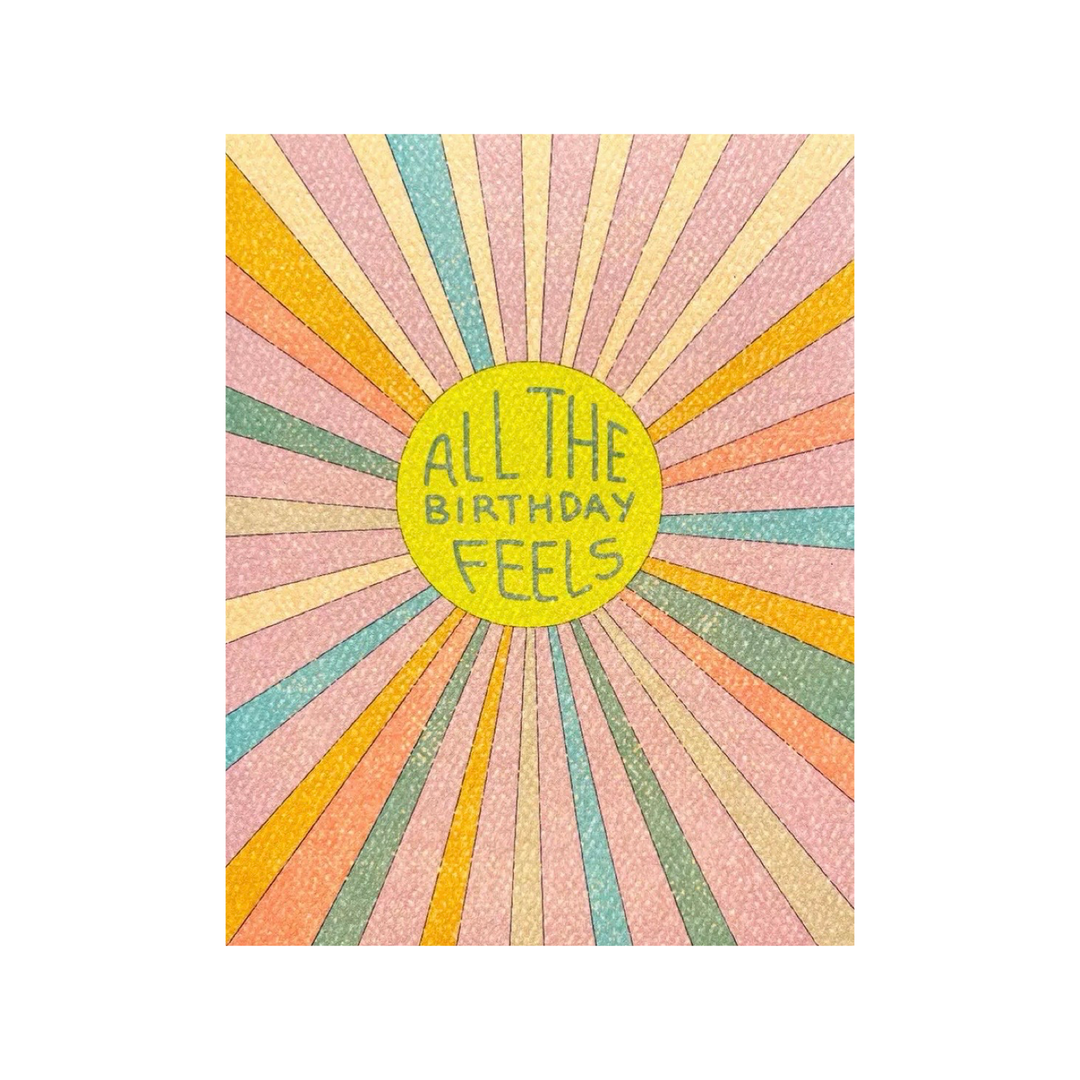 Birthday card with a colorful retro-style sunburst design radiating from a yellow circle that says "All the Birthday Feels." 