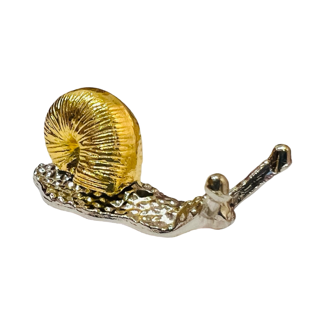 a gold and silver snail shaped incense holder