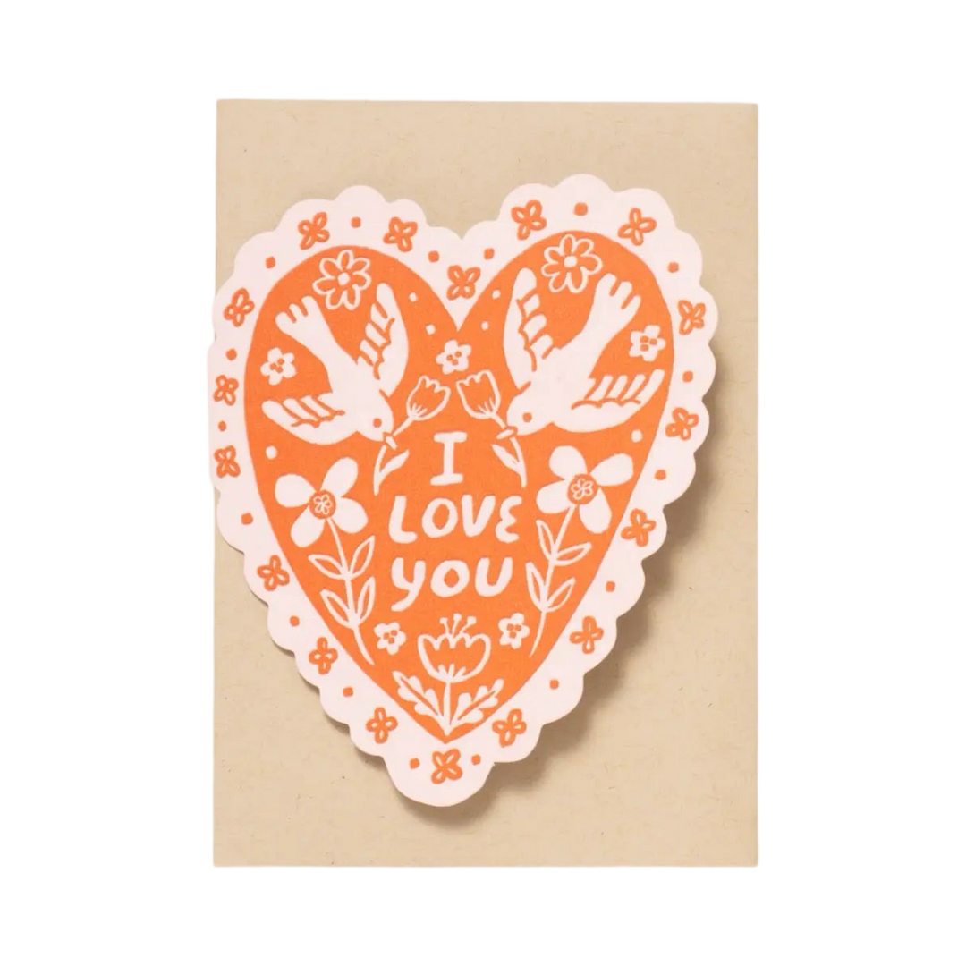 A heart-shaped greeting card with orange and white illustrations of doves, flowers, and the text "I Love You," paired with a kraft envelope.