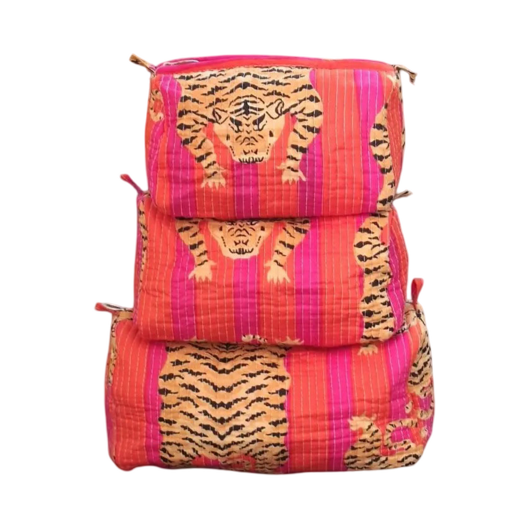 set of three cosmetic bags featuring a orange and pink and tiger-striped pattern.