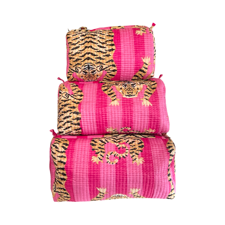 set of three cosmetic bags featuring a dual pink and tiger-striped pattern.