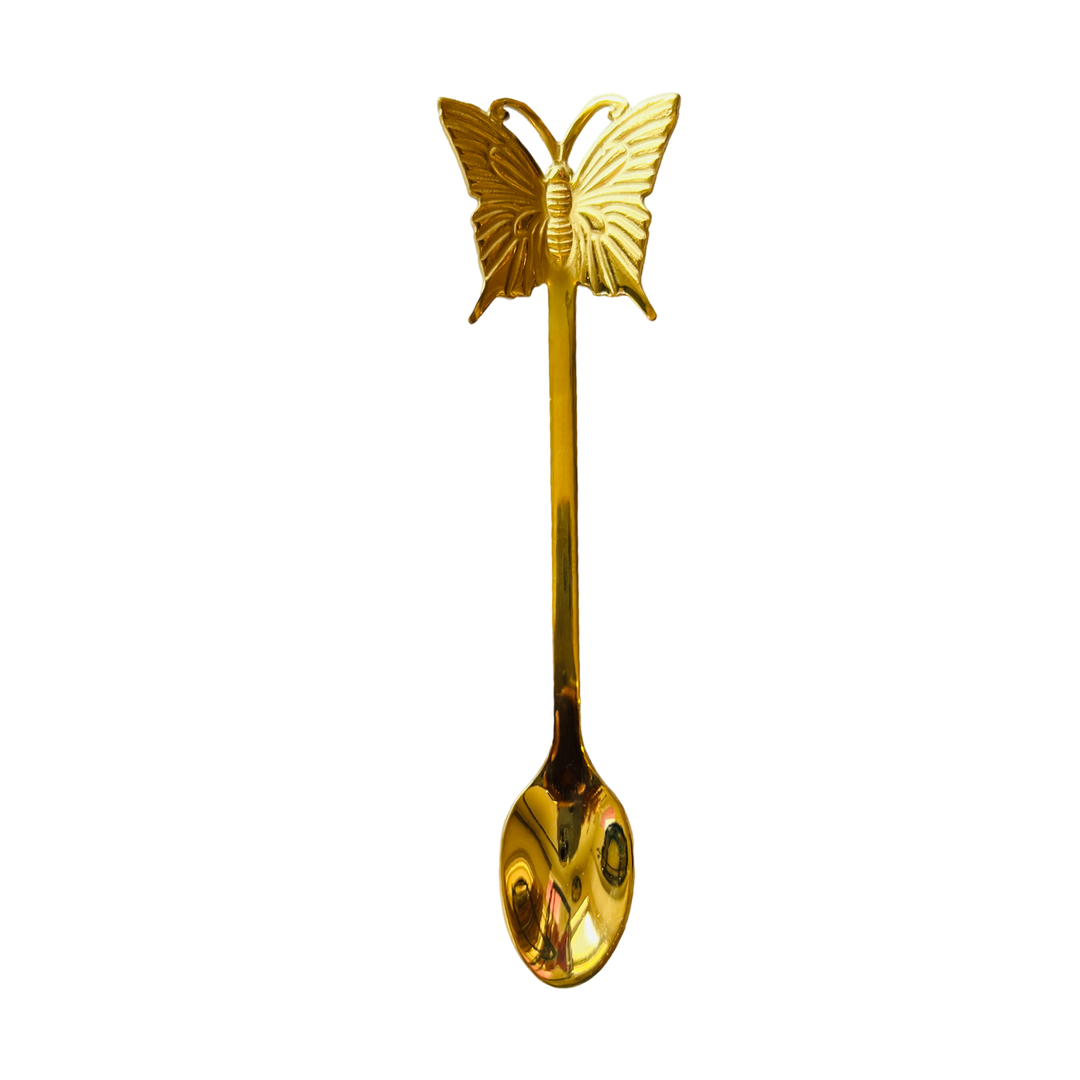 gold teaspoon with a butterfly on the handle